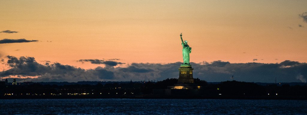 statue of liberty at sunset seen from Liberty Warehouse in Red Hook Brooklyn