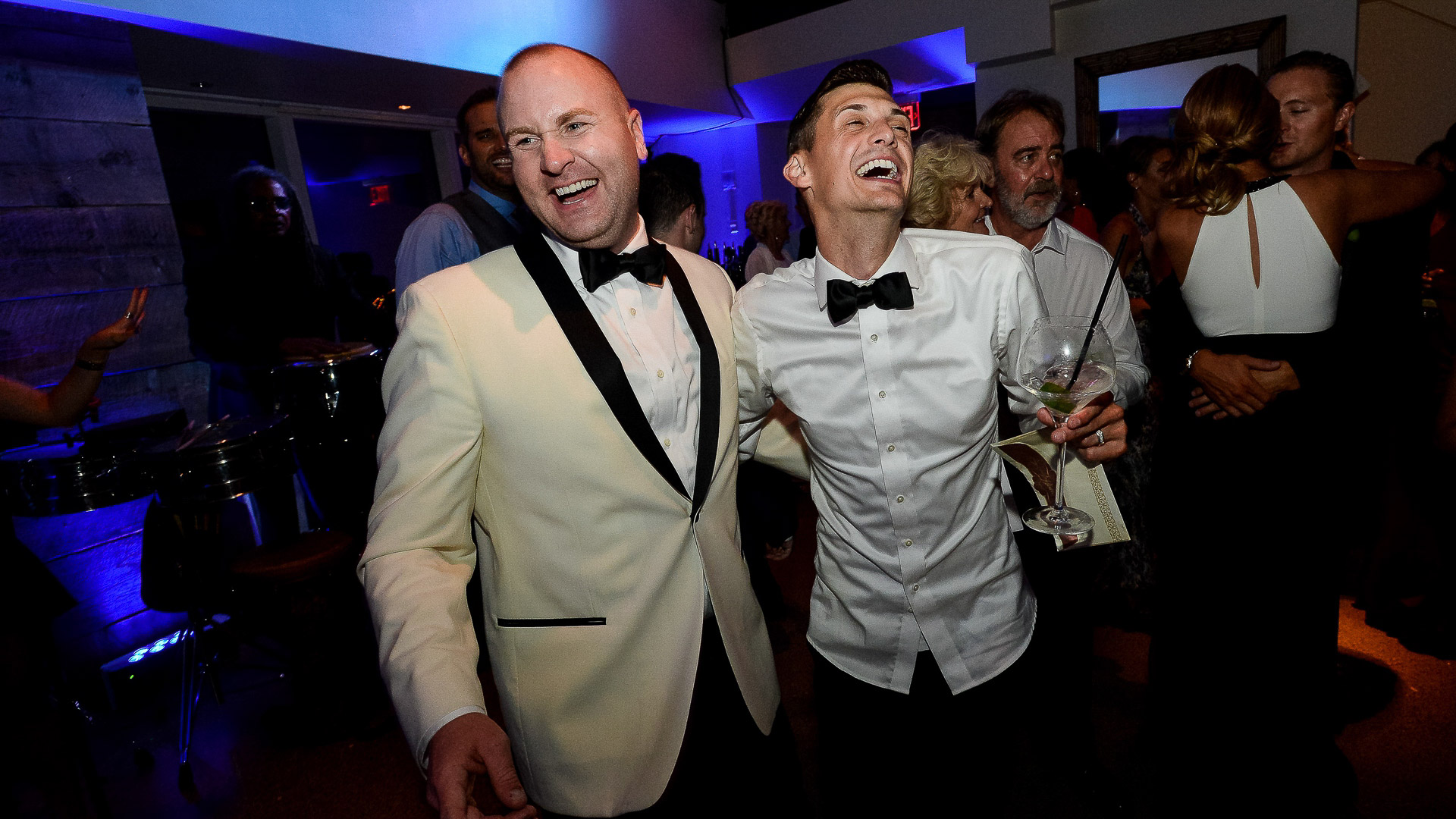 grooms laughing during reception